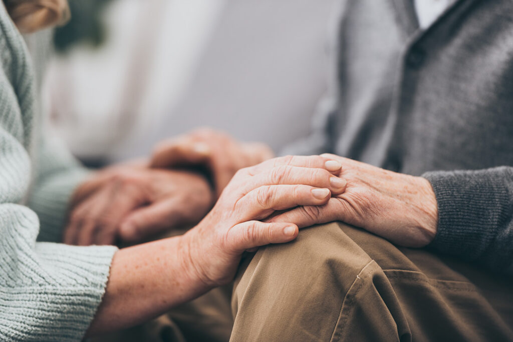elderly hands holding in a caring environment